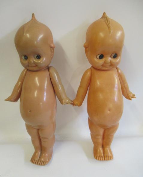 A pair of large celluloid Kewpie dolls, with sideways glancing eyes and jointed Image