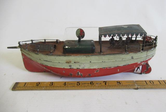 A Carrett clockwork pleasure boat with tin canopy and passengers, clockwork motor tested Image
