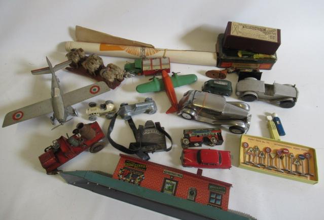 Tinplate toys comprising aircraft, cars, railway station and Dinky road traffic signs, some rusting Image