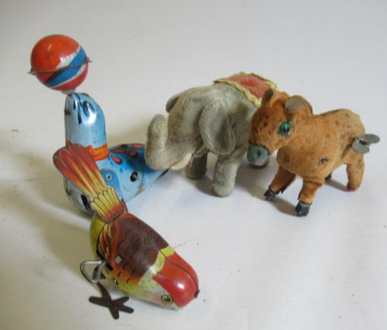 Four clockwork tin animals comprising walking elephant, donkey, sea lion and small bird, F (Est. Image
