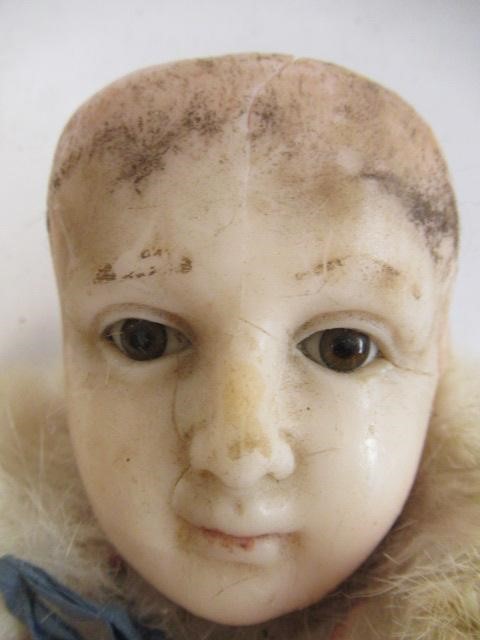 A Victorian wax head doll, with brown glass fixed eyes, closed mouth, composition lower limbs, Image