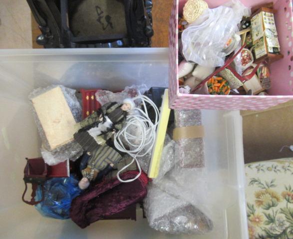 A box of dolls house furniture, including mainly wooden furniture, two dolls and a small box of shop Image