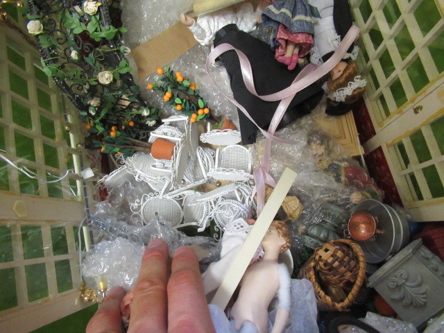 A box of dolls house dolls and outside accessories, including a conservatory, wire work pagoda and Image