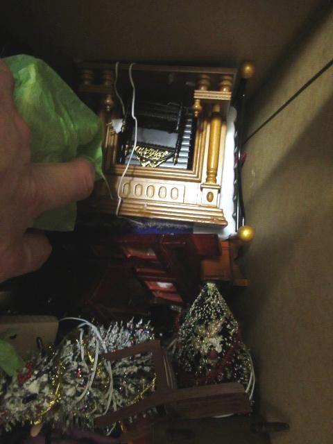 A large box of dolls house furniture and accessories, including mainly wooden furniture, a metal Image