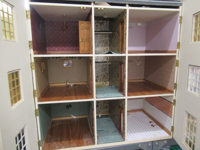 A Georgian style "Anglesey Dolls Houses" dolls house, with three hinged openings revealing twelve Image