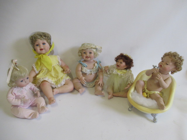 Five Ashton Drake baby dolls, all ceramic with jointed necks, shoulders and hips, one in a bath tub, Image