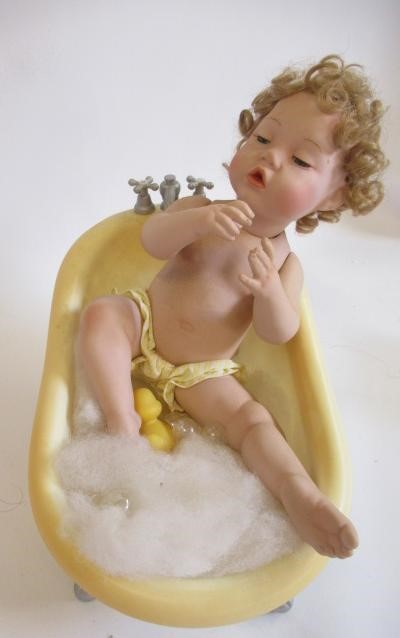 Five Ashton Drake baby dolls, all ceramic with jointed necks, shoulders and hips, one in a bath tub, Image