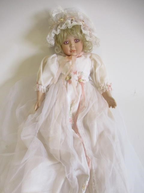 Six Ashton Drake all ceramic dolls, with jointed bodies and pink eyes, largest 17 1/2" long (Est. Image