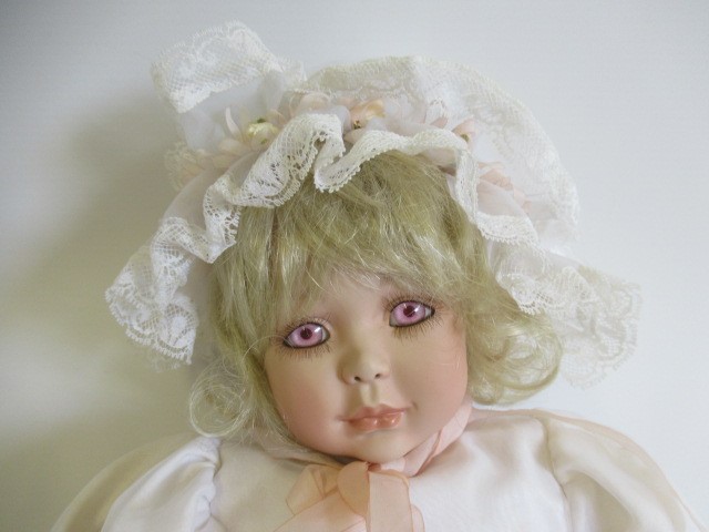 Six Ashton Drake all ceramic dolls, with jointed bodies and pink eyes, largest 17 1/2" long (Est. Image