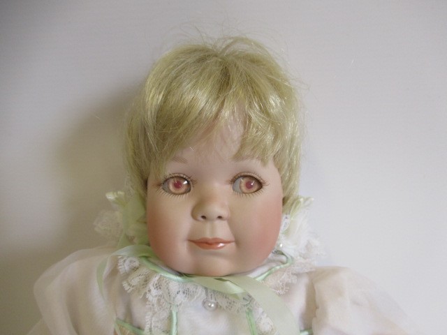 Six Ashton Drake all ceramic dolls, with jointed bodies and pink eyes, largest 17 1/2" long (Est. Image