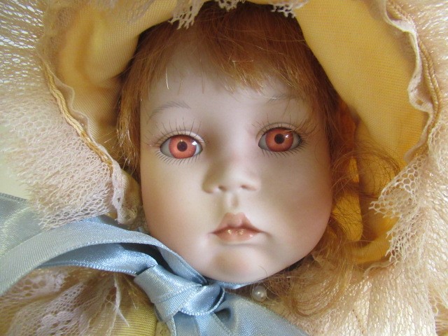 Six Ashton Drake all ceramic dolls, with jointed bodies and pink eyes, largest 17 1/2" long (Est. Image