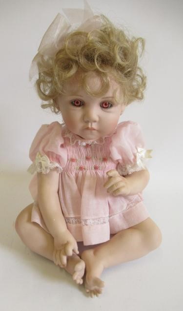 Six Ashton Drake all ceramic dolls, with jointed bodies and pink eyes, largest 17 1/2" long (Est. Image