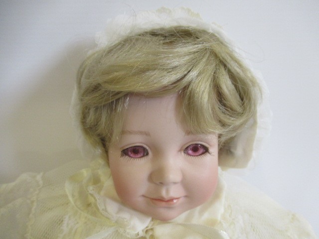 Six Ashton Drake all ceramic dolls, with jointed bodies and pink eyes, largest 17 1/2" long (Est. Image