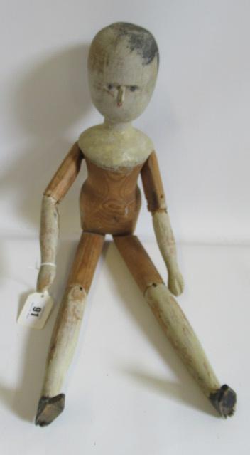 A large Victorian peg doll, of all wood construction with painted face and hair, remnents of painted Image