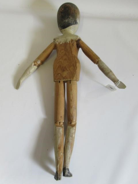A large Victorian peg doll, of all wood construction with painted face and hair, remnents of painted Image