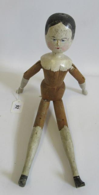 A large Victorian peg doll, of all wood construction with painted face and hair, painted lower Image