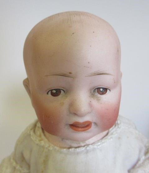 Three bisque head solemn boy dolls Image