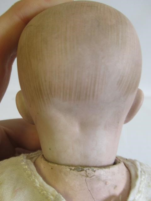 Three bisque head solemn boy dolls Image