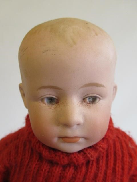 Three bisque head solemn boy dolls Image