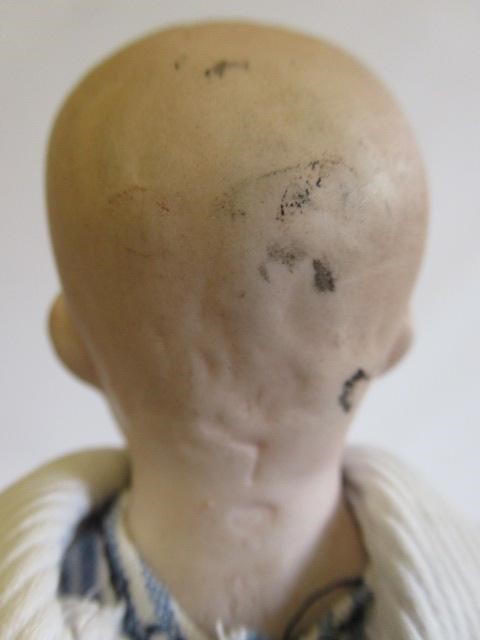 Three bisque head solemn boy dolls Image