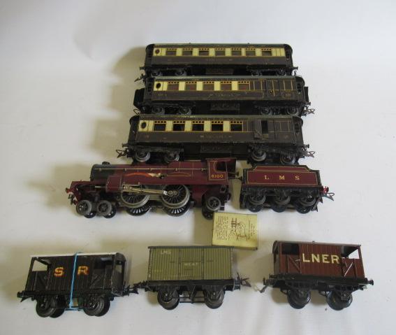 Hornby clockwork Royal Scot locomotive, three No.2 Pullman coaches and three goods trucks, some Image