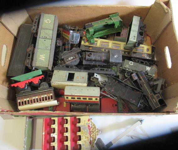 Playworn wagons, coaches and clockwork locomotives by Hornby and others, most items rusted or Image