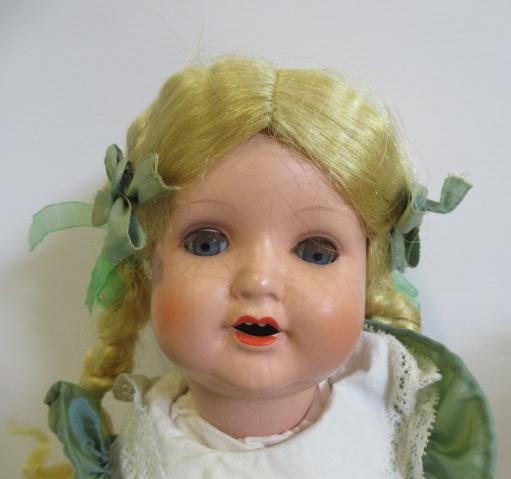 Four vintage dolls, including a celluloid walker, an English all composition jointed doll, a Image