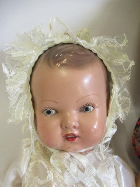 Four vintage dolls, including a celluloid walker, an English all composition jointed doll, a Image