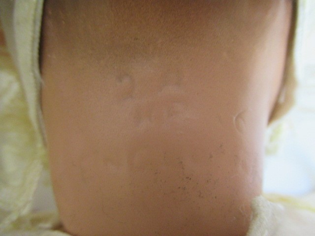 Four vintage dolls, including a celluloid walker, an English all composition jointed doll, a Image