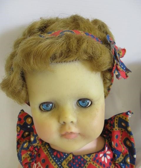 Four vintage dolls, including a celluloid walker, an English all composition jointed doll, a Image