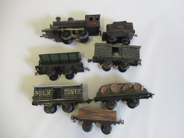 Bing electric 0-4-0 locomotive and tender finished in black with five goods wagons, some paint wear Image
