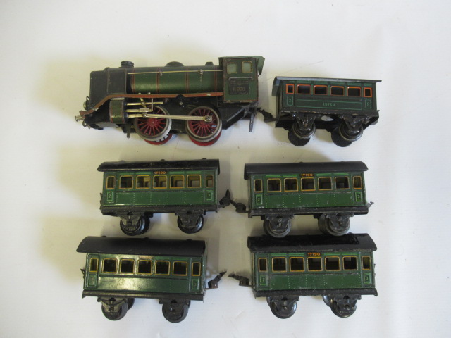 Marklin clockwork 0-4-0 locomotive finished in green R920 to cab, tender missing, with five coaches, Image