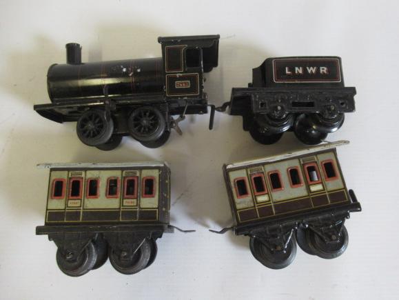 Bing clockwork 0-4-0 L.N.W.R. locomotive and tender with two small four wheel coaches, F-G (Est. Image