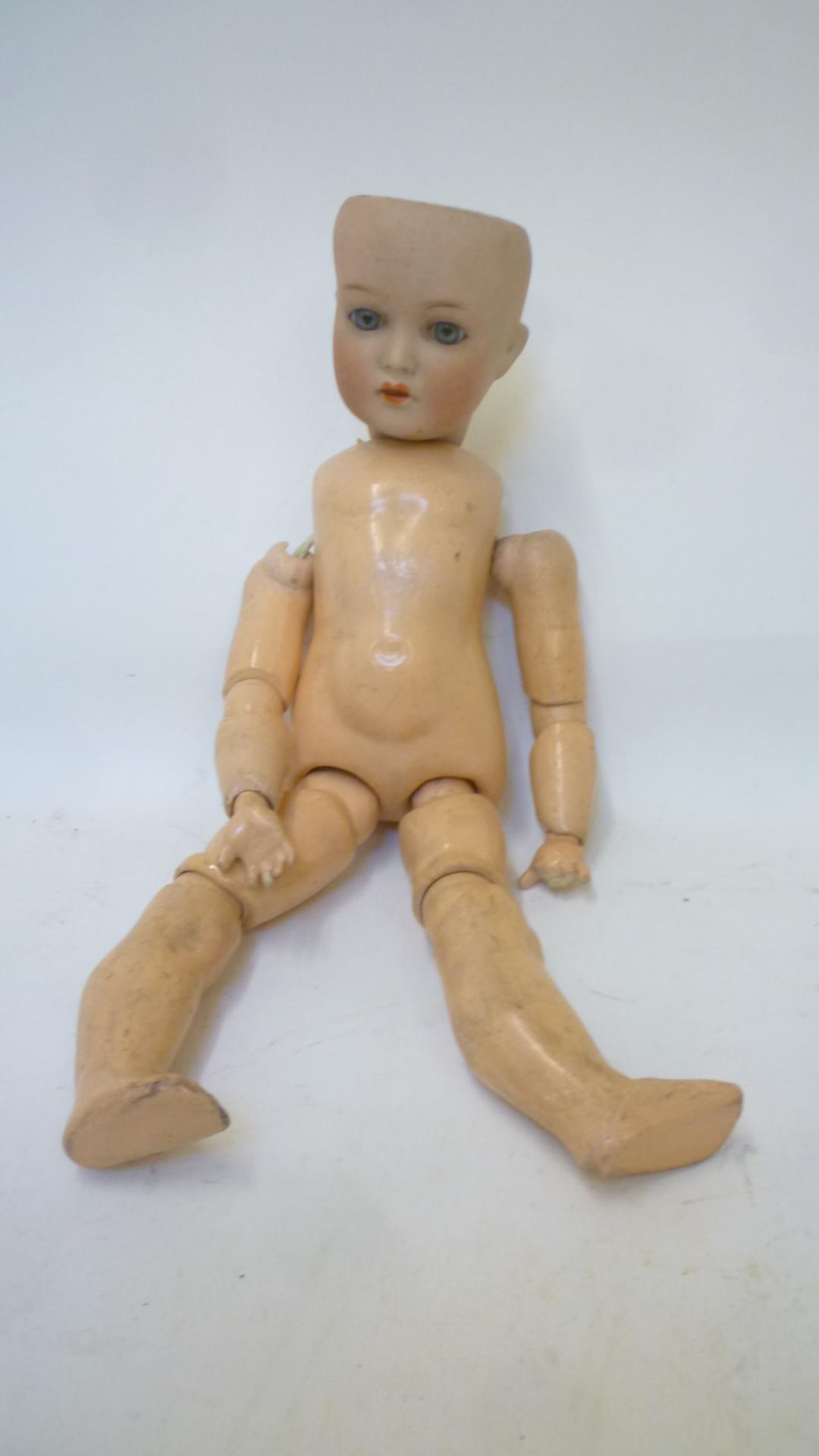 A Cuno and Otto Dressel bisque head doll with blue glass sleeping eyes Image