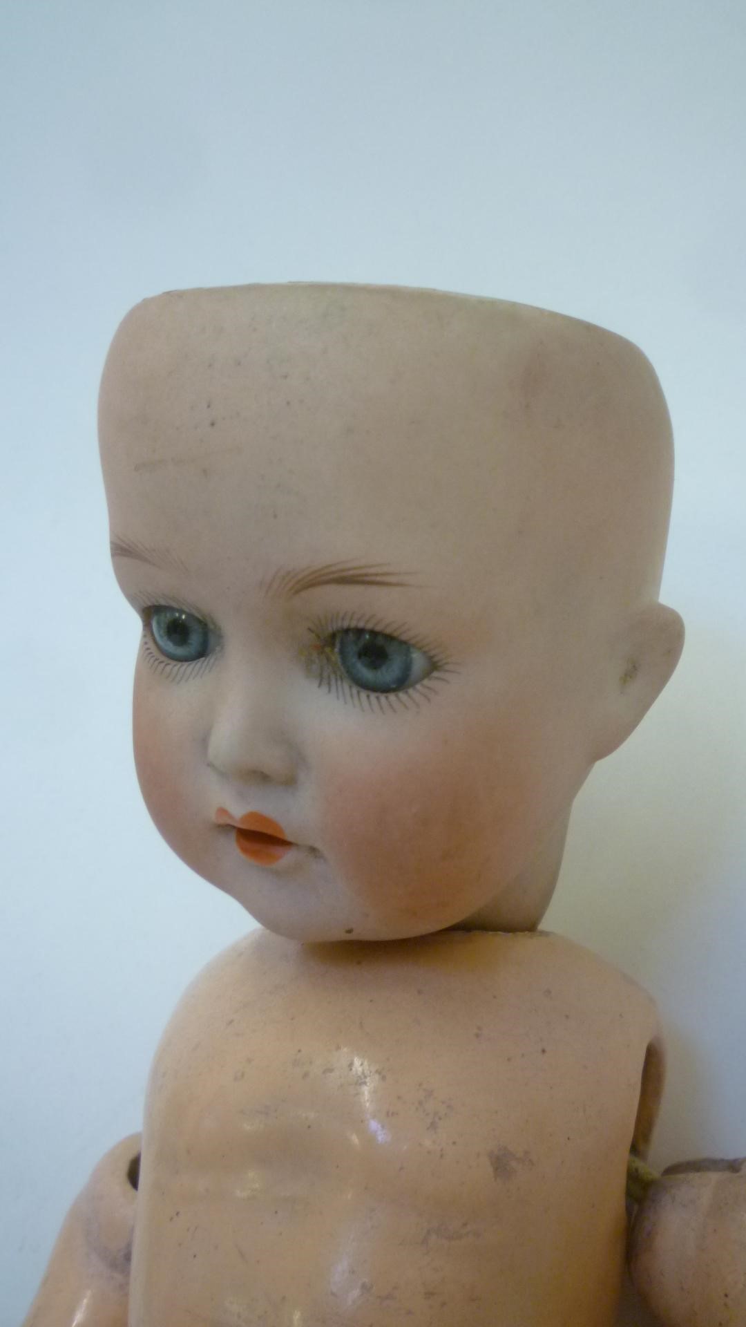 A Cuno and Otto Dressel bisque head doll with blue glass sleeping eyes Image
