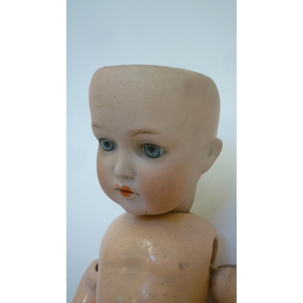 A Cuno and Otto Dressel bisque head doll with blue glass sleeping eyes Image