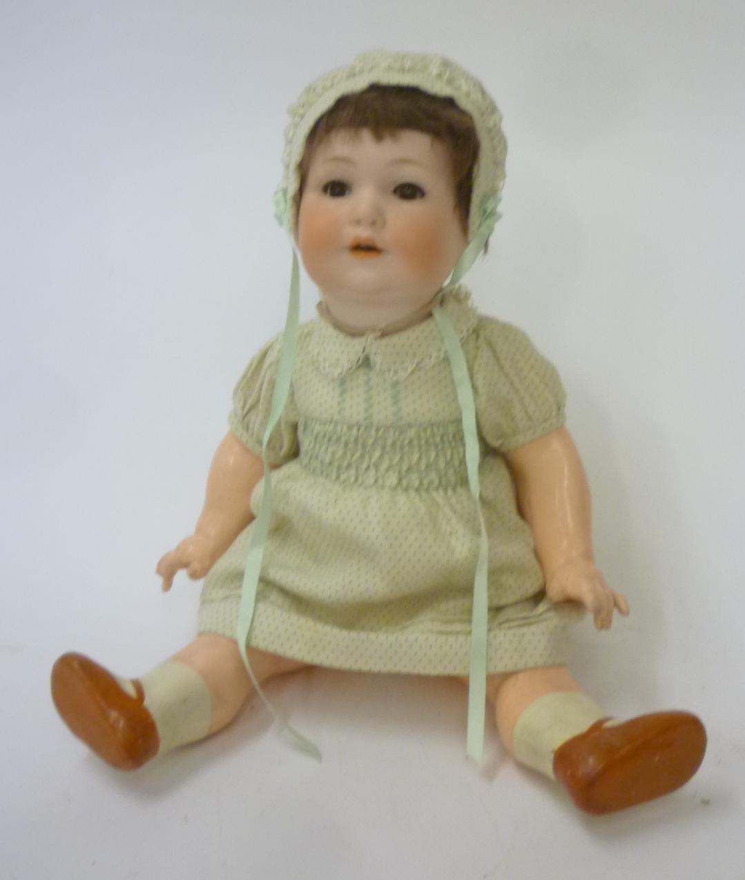An Armand Marseille bisque head character doll with brown glass sleeping eyes Image
