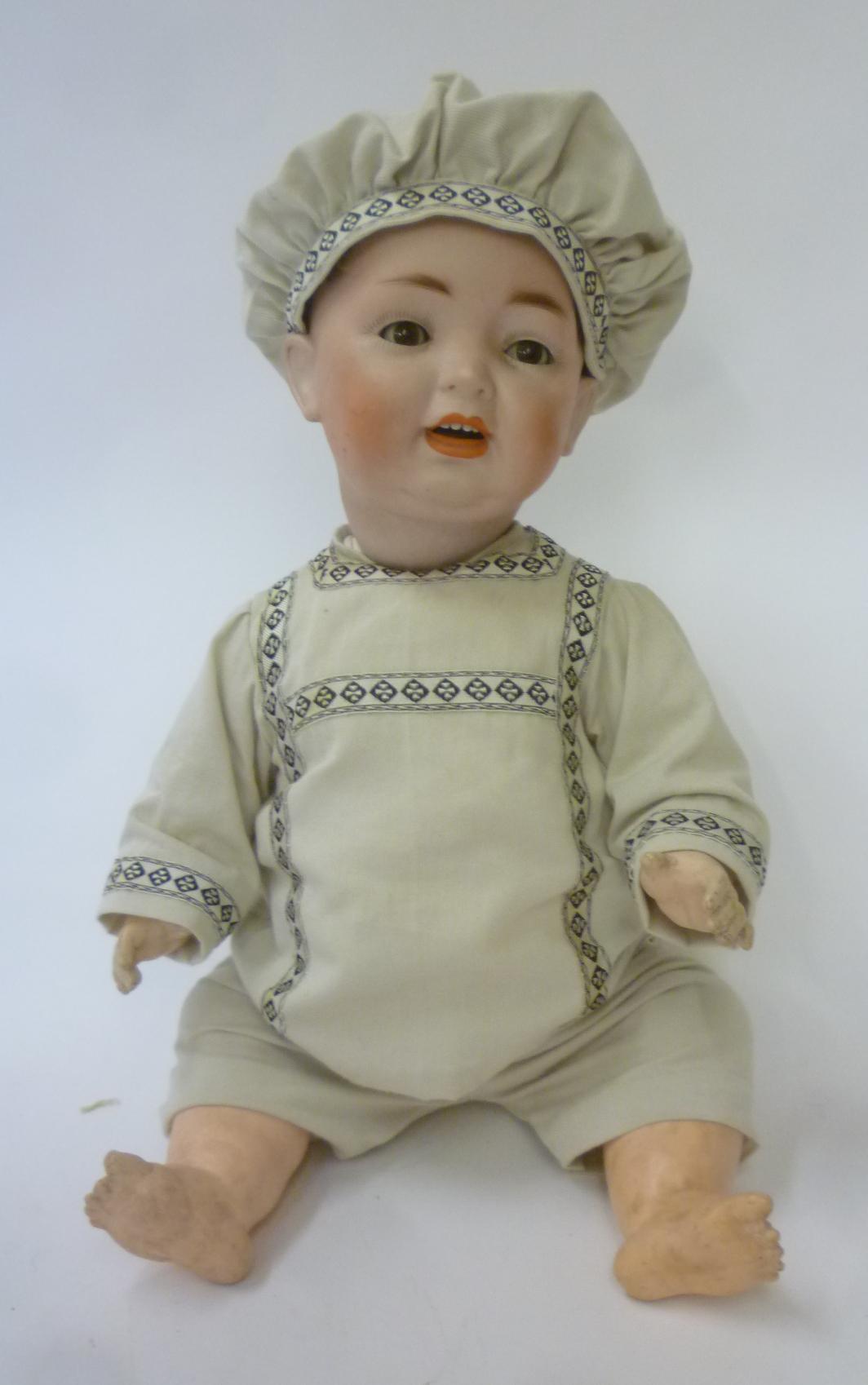A Kestner/Hertel Schwab & Co bisque head character boy doll with brown glass sleeping eyes Image