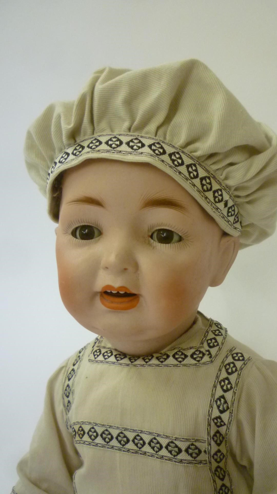 A Kestner/Hertel Schwab & Co bisque head character boy doll with brown glass sleeping eyes Image