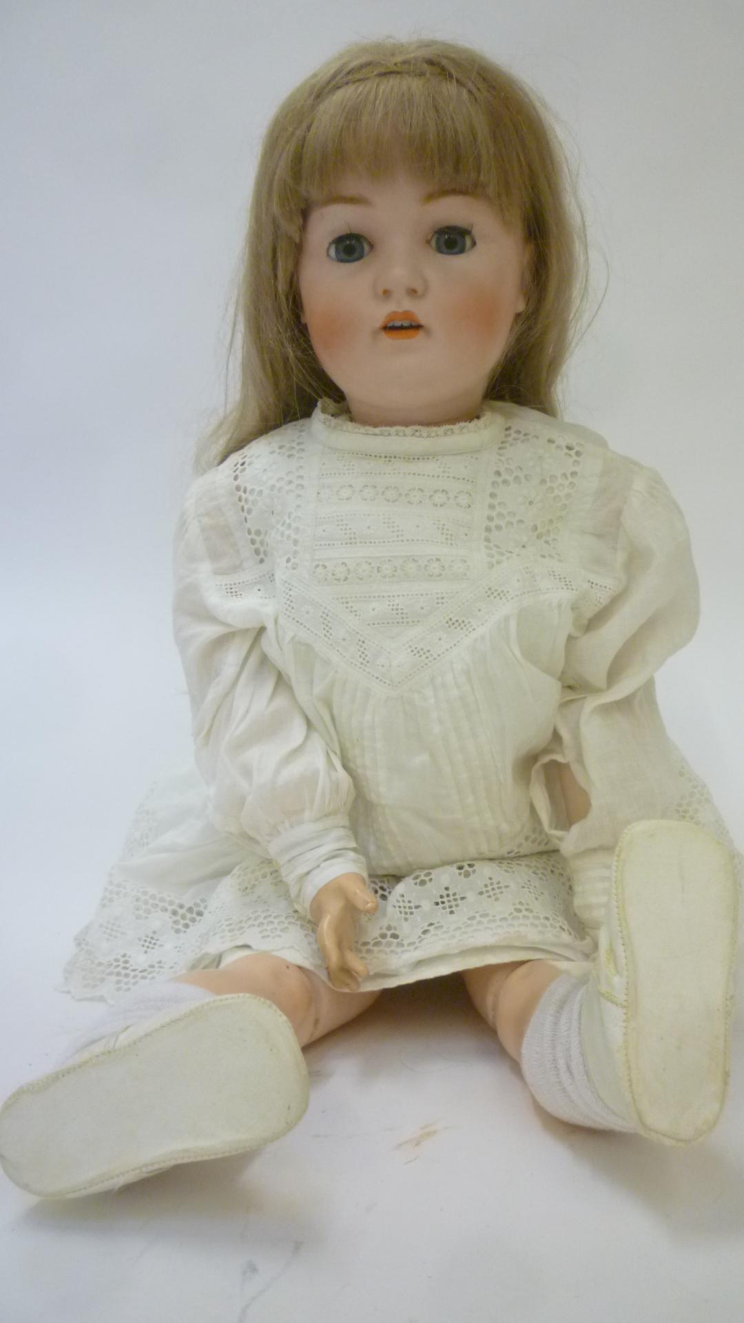 A Kestner bisque head doll with blue glass sleeping eyes Image
