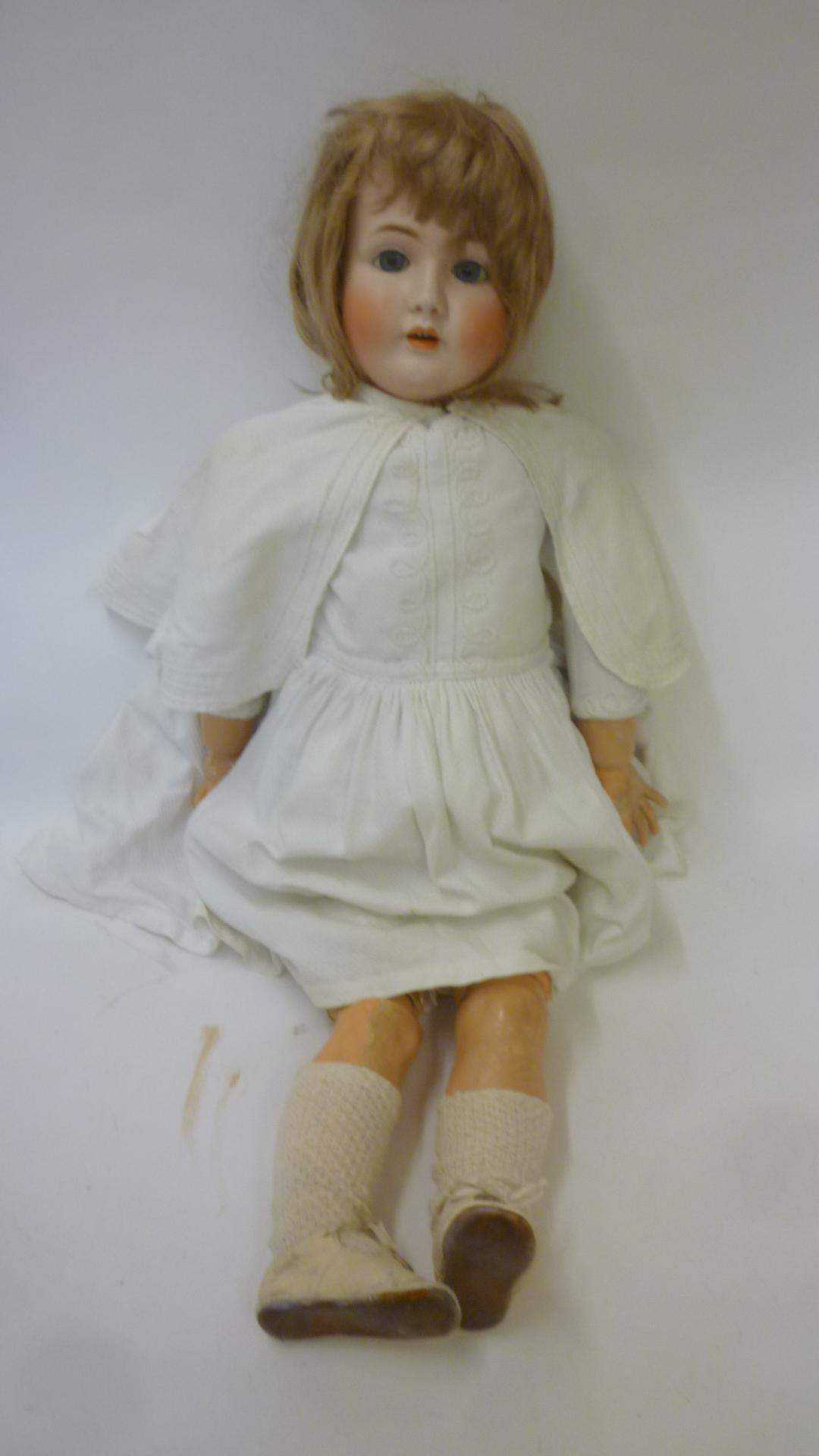 A Kestner bisque head doll with blue glass sleeping eyes Image