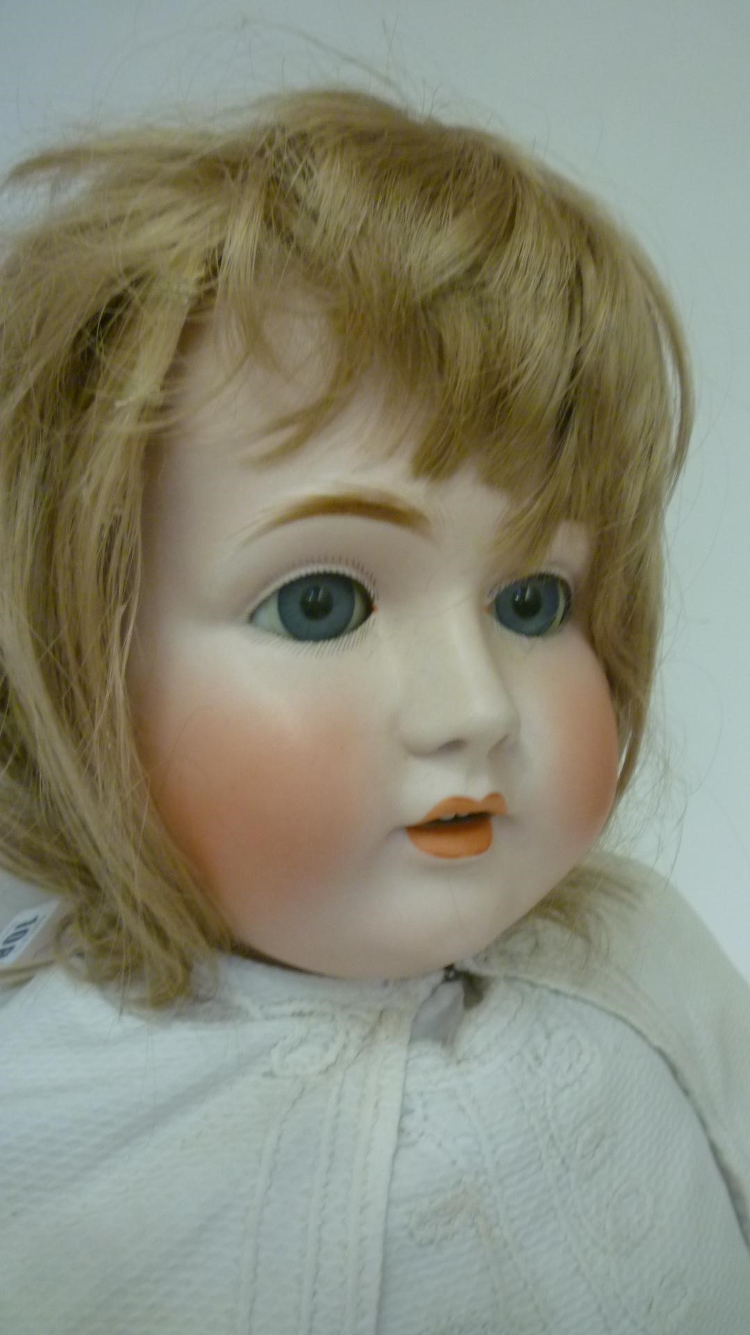 A Kestner bisque head doll with blue glass sleeping eyes Image