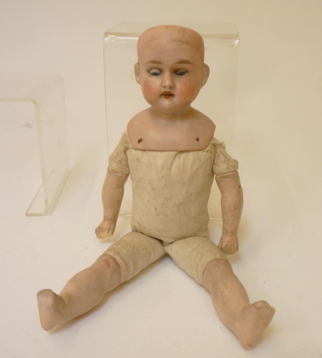 An Armand Marseille bisque shoulder head doll with blue glass sleeping eyes Image