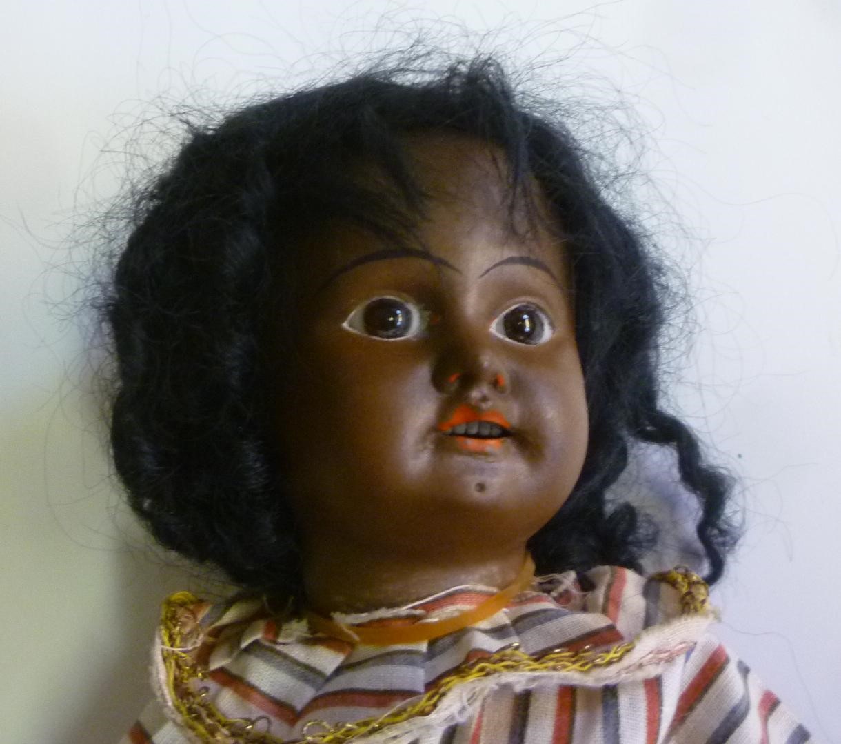 An early bisque head black doll with fixed brown glass eyes Image