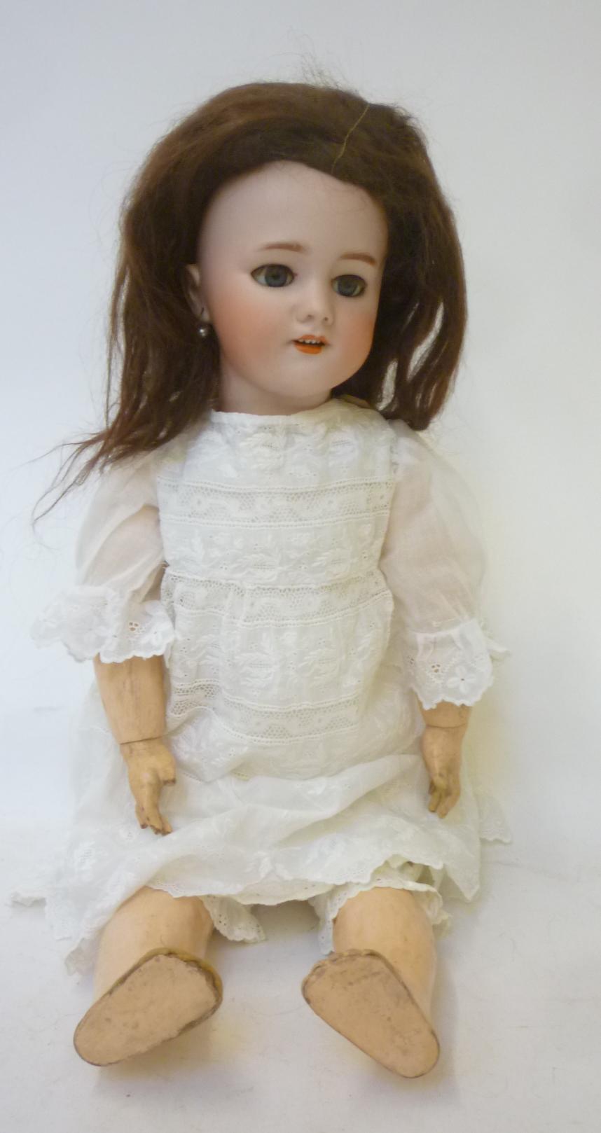 A French Dep bisque head doll with blue glass sleeping eyes Image