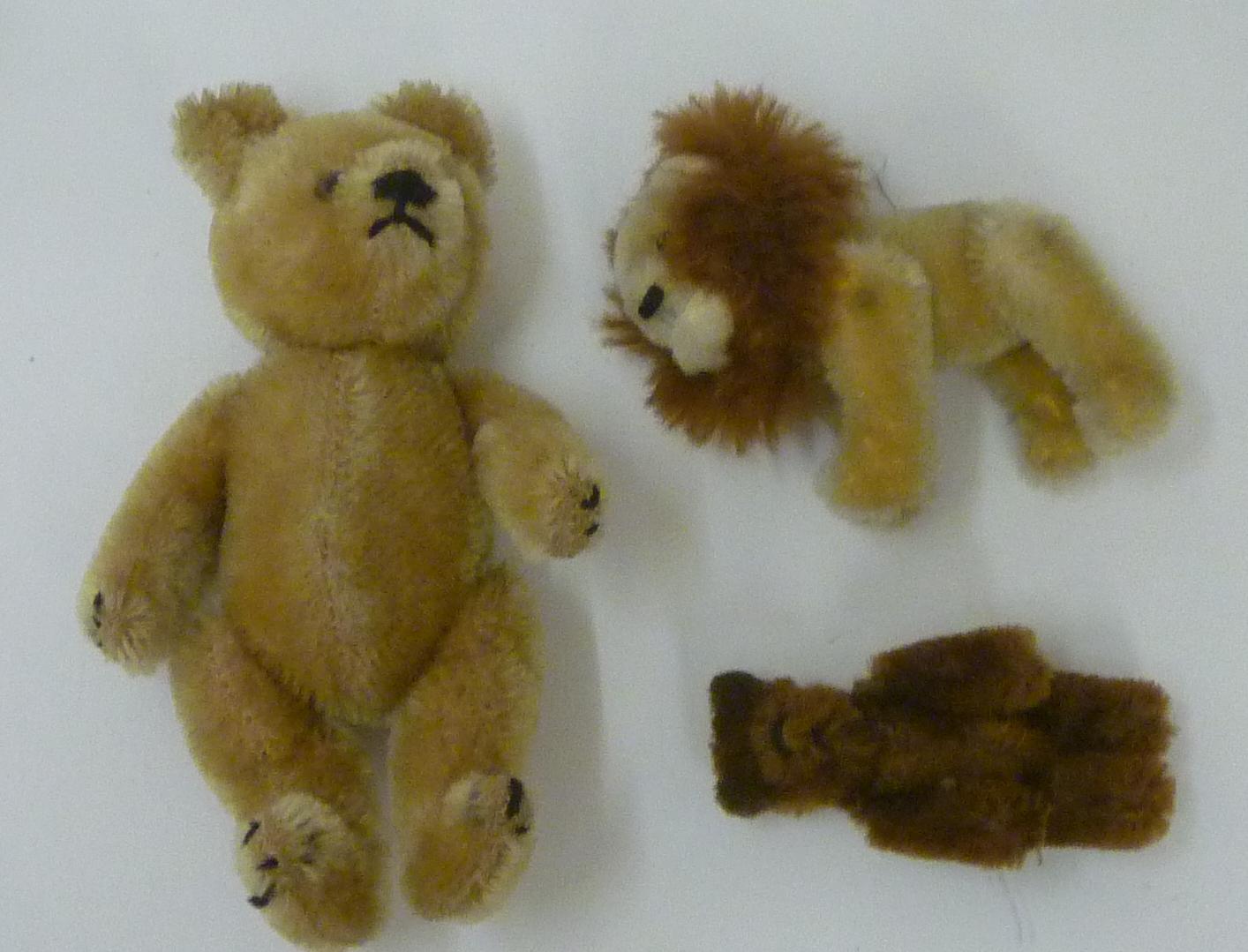 A Schuco miniature lion with button eyes Image