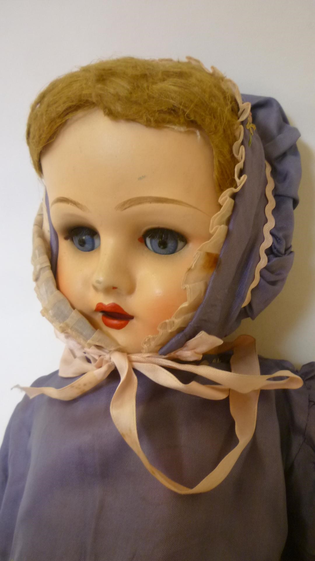 A Belgian sprayed bisque head doll Image