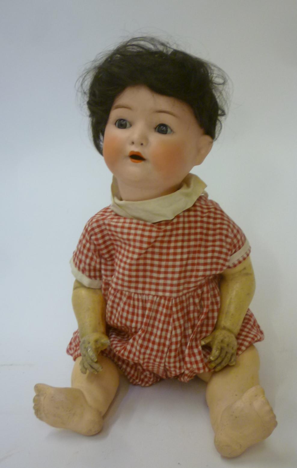 An Ernst Heubach bisque head doll with blue glass sleeping eyes and open mouth Image