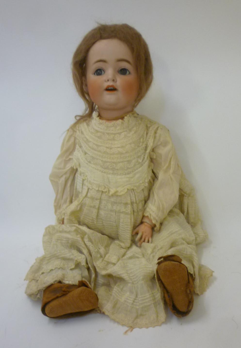 A Kestner bisque head flirty eyed doll with blue glass sleeping eyes Image