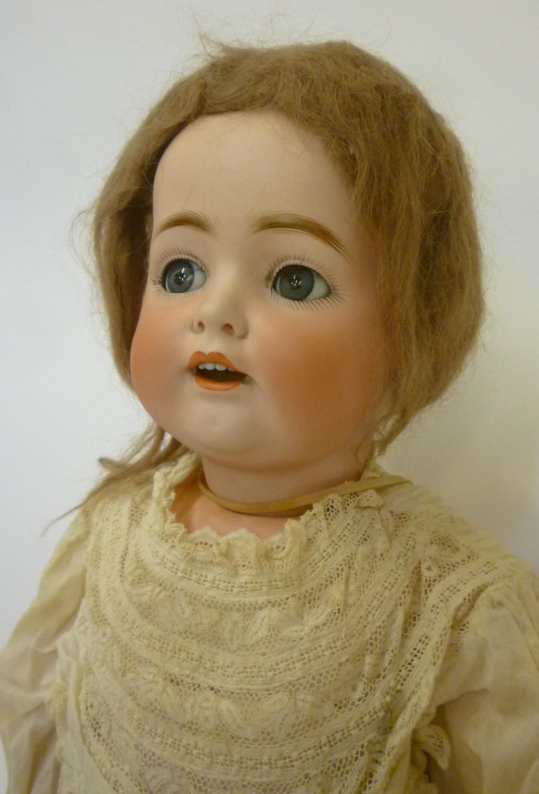 A Kestner bisque head flirty eyed doll with blue glass sleeping eyes Image